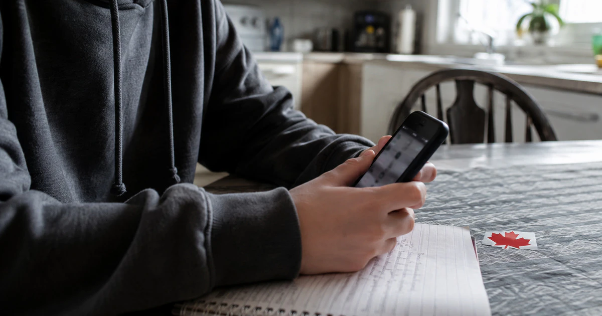A youth actively operating their phone